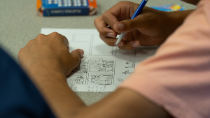 A student creating their own comic.