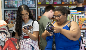 Two students looking at comics.