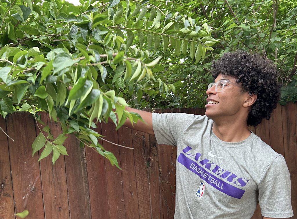 In the photo, McDowell trims down invasive honeysuckles at Columbia Montessori School.